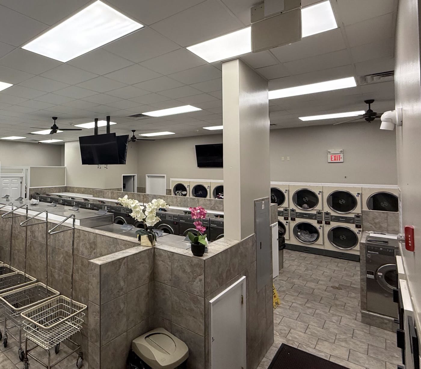 Row of large front-load washers inside the Soap Gnome laundromat